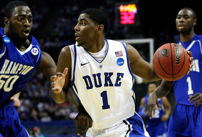 CHARLOTTE, NC - MARCH 18:  Kyrie Irving #1 of the Duke Blue Devils drives on Milade Lola-Charles #50 of the Hampton Pirates in the first half during the second round of the 2011 NCAA men's basketball tournament at Time Warner Cable Arena on March 18, 2011 in Charlotte, North Carolina.  (Photo by Kevin C. Cox/Getty Images)