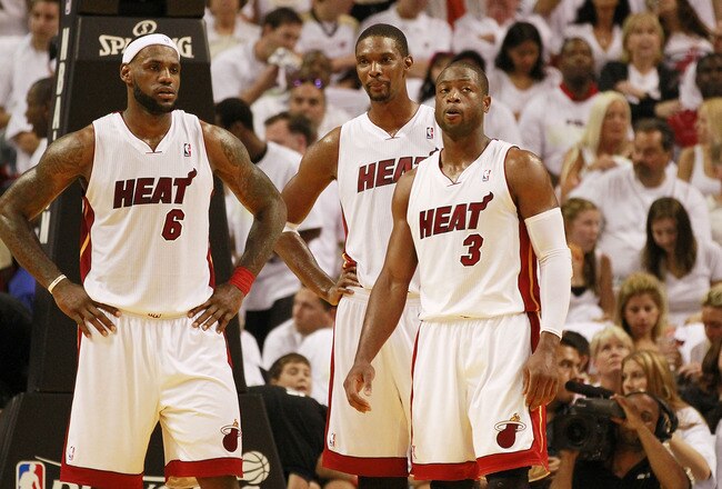 MIAMI, FL - APRIL 16:  Forward Chris Bosh #1 of the  Miami Heat with teammates Dwyane Wade #3 and LeBron James #6 against the Philadelphia 76ers at the American Airlines Arena in game one of the Eastern Conference Quarterfinals in the 2011 NBA Playoffs on April 16, 2011 in Miami, Florida. NOTE TO USER: User expressly acknowledges and agrees that, by downloading and or using this photograph, User is consenting to the terms and conditions of the Getty Images Liscence agreement.  (Photo by Marc Serota/Getty Images)