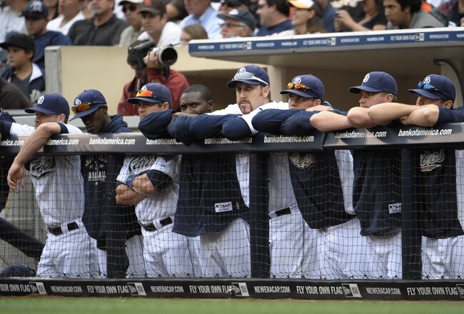 SAN DIEGO, CA - JUNE 8: San Diego Padres players look out from the dugout during the ninth inning of a baseball game against the Colorado Rockies at Petco Park on June 8, 2011 in San Diego, California. The Rockies won 5-3.  (Photo by Denis Poroy/Getty Images)