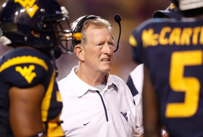 BATON ROUGE, LA - SEPTEMBER 25:  Head coach Bill Stewart of the West Virginia Mountaineers talks with his team during a timeout against the  Louisiana State University Tigers at Tiger Stadium on September 25, 2010 in Baton Rouge, Louisiana.  The Tigers defeated the Mountaineers 20-14.  (Photo by Chris Graythen/Getty Images)