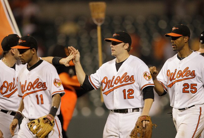 BALTIMORE, MD - JUNE 08: Mark Reynolds #12 of the Baltimore Orioles celebrates with teammates after the Orioles beat the Oakland Athletics 3-2 to sweep the series at Oriole Park at Camden Yards on June 8, 2011 in Baltimore, Maryland.  (Photo by Rob Carr/Getty Images)