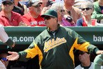 BOSTON, MA - JUNE 04:  David DeJesus #12 of the Oakland Athletics is congratulated by manager Bob Geren #17 and Coco Crisp #4 of the Oakland Athletics after DeJesus scored in the sixth inning against the Boston Red Sox on June 4, 2011 at Fenway Park in Boston, Massachusetts.  (Photo by Elsa/Getty Images)