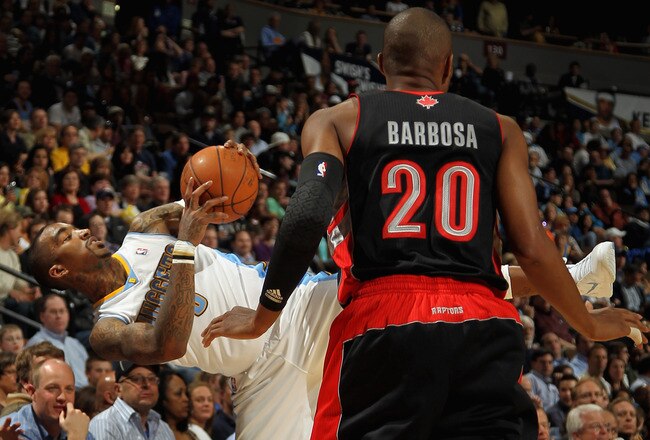 DENVER, CO - MARCH 21:  J.R. Smith #5 of the Denver Nuggets looses his balance after being fouled by Leandro Barbosa #20 of the Toronto Raptors at the Pepsi Center on March 21, 2011 in Denver, Colorado. The Nuggets defeated the Raptors 123-90. NOTE TO USER: User expressly acknowledges and agrees that, by downloading and or using this photograph, User is consenting to the terms and conditions of the Getty Images License Agreement.  (Photo by Doug Pensinger/Getty Images)