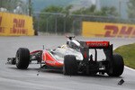MONTREAL, CANADA - JUNE 12:  Lewis Hamilton of Great Britain and McLaren suffers damage to his rear left wheel after driving too close to team mate Jenson Button of Great Britain and McLaren in the early stage of the Canadian Formula One Grand Prix at the Circuit Gilles Villeneuve on June 12, 2011 in Montreal, Canada.  (Photo by Paul Gilham/Getty Images)