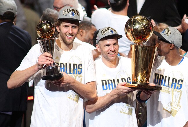 MIAMI, FL - JUNE 12:  (L-R) Finals MVP Dirk Nowitzki #41, Jason Kidd #2 and Jason Terry #31 of the Dallas Mavericks celebrate with the Larry O'Brien trophy after they won 105-95 against the Miami Heat in Game Six of the 2011 NBA Finals at American Airlines Arena on June 12, 2011 in Miami, Florida. NOTE TO USER: User expressly acknowledges and agrees that, by downloading and/or using this Photograph, user is consenting to the terms and conditions of the Getty Images License Agreement.  (Photo by Marc Serota/Getty Images)