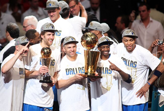 MIAMI, FL - JUNE 12:  (L-R) Brian Cardinal #35, Finals MVP Dirk Nowitzki #41, Jason Kidd #2, Jason Terry #31 and Shawn Marion #0 of the Dallas Mavericks celebrate with the Larry O'Brien trophy after they won 105-95 against the Miami Heat in Game Six of the 2011 NBA Finals at American Airlines Arena on June 12, 2011 in Miami, Florida. NOTE TO USER: User expressly acknowledges and agrees that, by downloading and/or using this Photograph, user is consenting to the terms and conditions of the Getty Images License Agreement.  (Photo by Marc Serota/Getty Images)