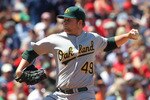 BOSTON, MA - JUNE 5: Brett Anderson #49 of the Oakland Athletics throws against the Boston Red Sox at Fenway Park on June 5, 2011 in Boston, Massachusetts.  (Photo by Jim Rogash/Getty Images)