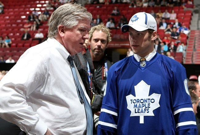 MONTREAL, QC - JUNE 27:  Kenny Ryan speaks to General Manager Brian Burke of the Toronto Maple Leafs organization after he was drafted by the Leafs in the second round during the 2009 NHL Entry Draft at the Bell Centre on June 27, 2009 in Montreal, Quebec, Canada. (Photo by Bruce Bennett/Getty Images)