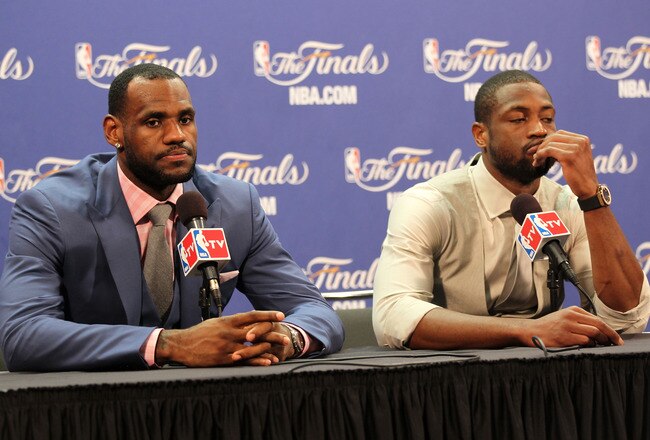MIAMI, FL - JUNE 12:  LeBron James #6 and Dwyane Wade #3 of the Miami Heat answer questions after the Heat were defeated 105-95 by the Dallas Mavericks in Game Six of the 2011 NBA Finals at American Airlines Arena on June 12, 2011 in Miami, Florida. NOTE TO USER: User expressly acknowledges and agrees that, by downloading and/or using this Photograph, user is consenting to the terms and conditions of the Getty Images License Agreement.  (Photo by Mike Ehrmann/Getty Images)