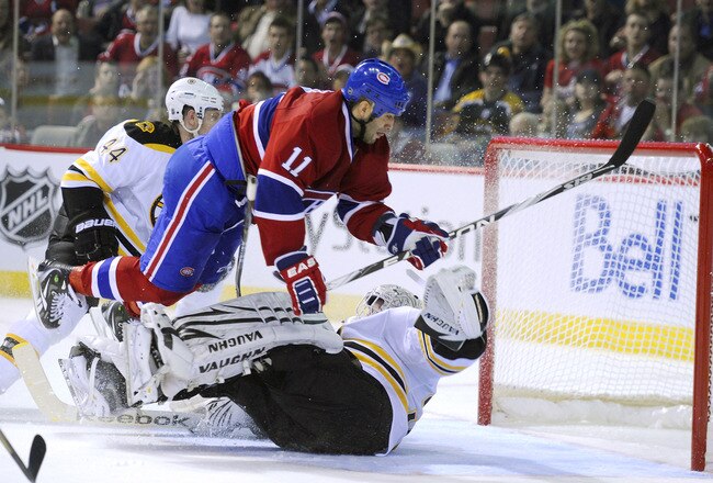MONTREAL, CANADA - APRIL 26:  Scott Gomez #11 of the Montreal Canadiens goes airborne over a sprawled out Tim Thomas #30 of the Boston Bruins in Game Six of the Eastern Conference Quarterfinals during the 2011 NHL Stanley Cup Playoffs at the Bell Centre on April 26, 2011 in Montreal, Canada.  (Photo by Phillip MacCallum/Getty Images)