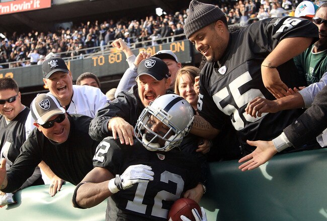OAKLAND, CA - NOVEMBER 28:  Jacoby Ford #12 of the Oakland Raiders is congratulated by fan after he scored a touchdown against the Miami Dolphins at Oakland-Alameda County Coliseum on November 28, 2010 in Oakland, California.  (Photo by Ezra Shaw/Getty Images)
