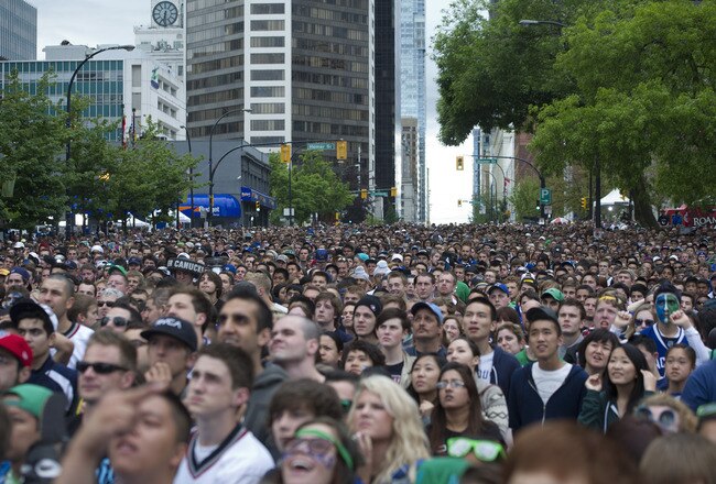 VANCOUVER, CANADA - JUNE 13: Fans gather on the streets of downtown Vancouver to watch Game Six of the 2011 NHL Stanley Cup Playoffs on June 13, 2011 in Vancouver, British Columbia, Canada.  (Photo by Rich Lam/Getty Images)