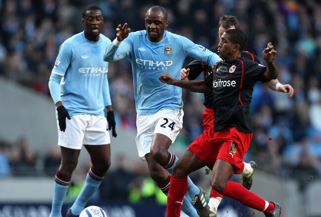 MANCHESTER, ENGLAND - MARCH 13:  Patrick Vieira of Manchester City is tackled by Mikele Leigertwood of Reading during the FA Cup sponsored by E.On Sixth Round match between Manchester City and Reading at the City of Manchester Stadium on March 13, 2011 in Manchester, England.  (Photo by Ian Walton/Getty Images)