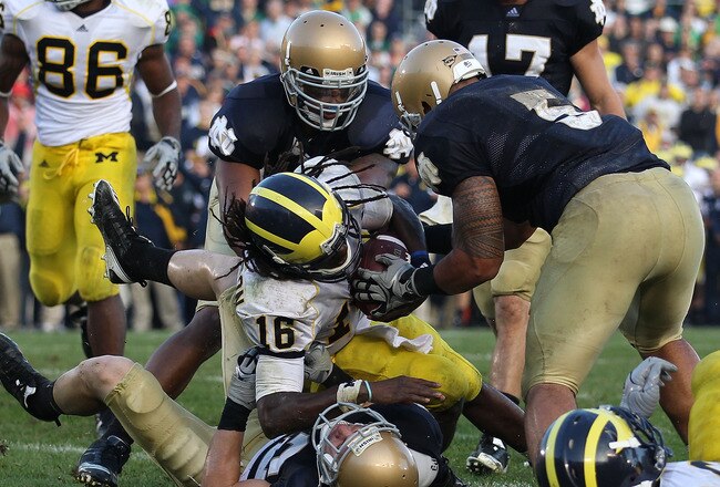 SOUTH BEND, IN - SEPTEMBER 11: Denard Robinson #16 of the Michigan Wolverines dives into the end zone for the game-winning touchdown as Harrison Smith #22 of the Notre Dame Fighting Irish brings him down while Manti Te'o #5 tries to grab the ball at Notre Dame Stadium on September 11, 2010 in South Bend, Indiana. Michigan defeated Notre Dame 28-24. (Photo by Jonathan Daniel/Getty Images)