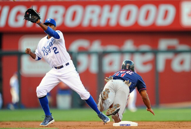 KANSAS CITY, MO - JUNE 3: Ben Revere #11 of the Minnesota Twins slides in with a stolen base as Alcides Escobar #2 of the Kansas City Royals takes the throw at Kauffman Stadium on June 3, 2011 in Kansas City, Missouri. (Photo by G. Newman Lowrance/Getty Images)