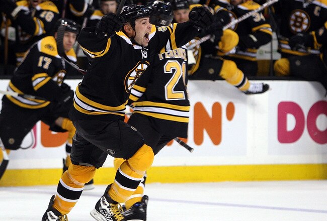 BOSTON - APRIL 13:  Marc Savard #91 of the Boston Bruins and the rest of his teammates celebrate his overtime goal during game three of the 2008 NHL Eastern Conference Quarterfinals on April 13, 2008 at the TD Banknorth Garden in Boston, Massachusetts.   (Photo by Elsa/Getty Images)