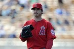 PHOENIX, AZ - FEBRUARY 27:  Scott Kazmir #22 of the Los Angeles Angels of Anaheim reacts to a hit by the Los Angeles Dodgers during spring training at Camelback Ranch on February 27, 2011 in Phoenix, Arizona.  (Photo by Harry How/Getty Images)
