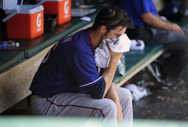 CLEVELAND, OH - JUNE 5: Starting pitcher C.J. Wilson #36 of the Texas Rangers reacts to being taken out of the game just short of a complete game during the eighth inning against the Cleveland Indians at Progressive Field on June 5, 2011 in Cleveland, Ohio. The Rangers defeated the Indians 2-0 and swept the four game series. (Photo by Jason Miller/Getty Images)