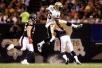 NEW ORLEANS - AUGUST 21:  Reggie Bush #25 of the New Orleans Saints jumps over Brice McCain #21 of the Houston Texans at the Louisiana Superdome on August 21, 2010 in New Orleans, Louisiana.  (Photo by Chris Graythen/Getty Images)