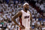 MIAMI, FL - JUNE 12:  LeBron James #6 of the Miami Heat looks on as Dwyane Wade stands in the background against the Dallas Mavericks in Game Six of the 2011 NBA Finals at American Airlines Arena on June 12, 2011 in Miami, Florida. NOTE TO USER: User expressly acknowledges and agrees that, by downloading and/or using this Photograph, user is consenting to the terms and conditions of the Getty Images License Agreement.  (Photo by Mike Ehrmann/Getty Images)