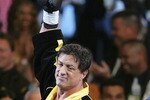 LAS VEGAS - DECEMBER 03:  Actor Sylvester Stallone waves to the crowd as scenes from the film 'Rocky VI' are filmed before the start of the Bernard Hopkins and Jermain Taylor fight at the Mandalay Bay Events Center on December 3, 2005 in Las Vegas, Nevada.  (Photo by Ethan Miller/Getty Images)