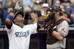 TORONTO, CANADA - JUNE 15:  Yunel Escobar #5 of the Toronto Blue Jays celebrates his home run in front of Matt Wieters #32 of the Baltimore Orioles during MLB action at The Rogers Centre June 15, 2011 in Toronto, Ontario, Canada. (Photo by Abelimages/Getty Images)