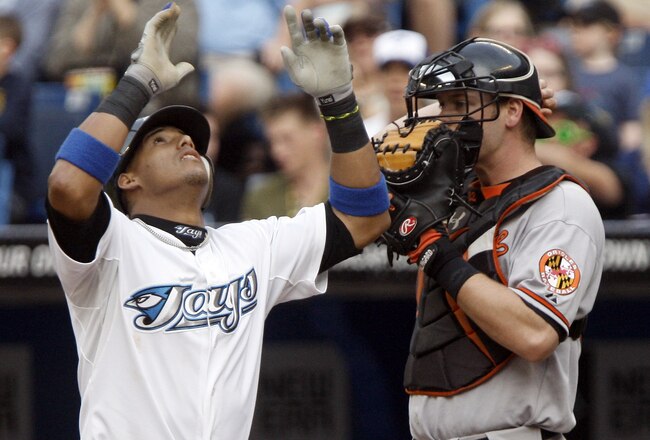TORONTO, CANADA - JUNE 15:  Yunel Escobar #5 of the Toronto Blue Jays celebrates his home run in front of Matt Wieters #32 of the Baltimore Orioles during MLB action at The Rogers Centre June 15, 2011 in Toronto, Ontario, Canada. (Photo by Abelimages/Getty Images)