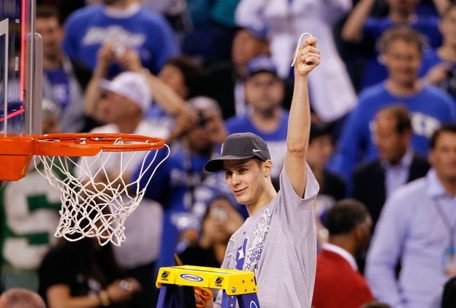 INDIANAPOLIS - APRIL 05:  Jon Scheyer of the Duke Blue Devils celebrates after he cut down a piece of the net following their 61-59 win against the Butler Bulldogs during the 2010 NCAA Division I Men's Basketball National Championship game at Lucas Oil Stadium on April 5, 2010 in Indianapolis, Indiana.  (Photo by Kevin C. Cox/Getty Images)