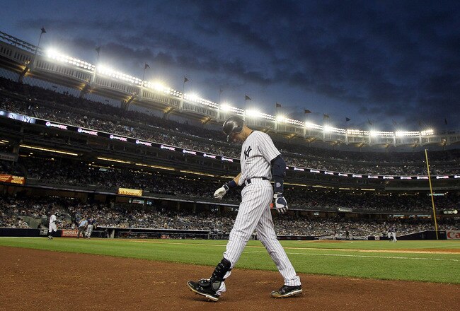 NEW YORK, NY - JUNE 13:  Derek Jeter #2 of the New York Yankees walks back to the dugout after flying out in the fifth inning against the Cleveland Indians on June 13, 2011 at Yankee Stadium in the Bronx borough of New York City. Jeter suffered a sore right calf on the play and left the game. (Photo by Jim McIsaac/Getty Images)