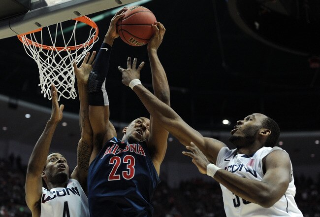ANAHEIM, CA - MARCH 26:  Derrick Williams #23 of the Arizona Wildcats goes up for a rebound against Jamal Coombs-McDaniel #4 and Charles Okwandu #35 of the Connecticut Huskies during the west regional final of the 2011 NCAA men's basketball tournament at the Honda Center on March 26, 2011 in Anaheim, California.  (Photo by Harry How/Getty Images)