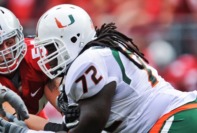 COLUMBUS, OH - SEPTEMBER 11:  John Simon #54 of the Ohio State Buckeyes is blocked by Brandon Washington #72 of the Miami Hurricanes at Ohio Stadium on September 11, 2010 in Columbus, Ohio.  (Photo by Jamie Sabau/Getty Images)