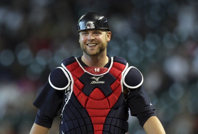 HOUSTON - JUNE 12:  Catcher Brian McCann #16 of the Atlanta Braves reacts after Jason Michaels #4 of the Houston Astros was called safe at first base on a close call at Minute Maid Park on June 12, 2011 in Houston, Texas.  (Photo by Bob Levey/Getty Images)