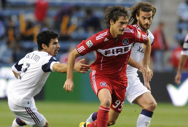 BRIDGEVIEW, IL - JUNE 22:  Kyle Beckerman #5 of Real Salt Lake (R)  Tony Beltran #2 (L) and Diego Chaves #99 of the Chicago Fire (C) fight for the ball in an MLS match on June 22, 2011 at Toyota Park in Bridgeview, Illinois.  (Photo by David Banks/Getty Images)