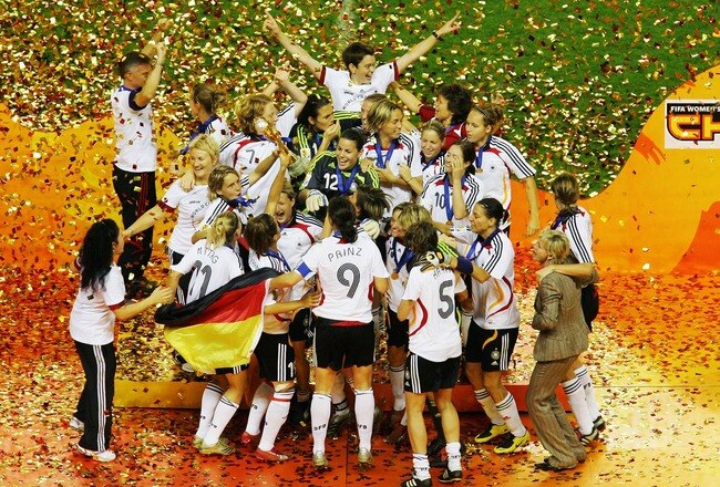 SHANGHAI, CHINA - SEPTEMBER 30:  The German team celebrate victory on the podium after winning the Women's World Cup 2007 Final match between Brazil and Germany at the Shanghai Hongkou Football Stadium September 30, 2007 in Shanghai, China.(Photo by Feng Li/Getty Images)