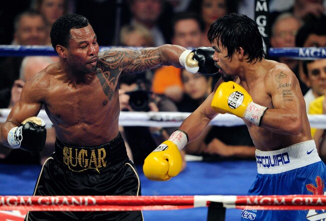 LAS VEGAS, NV - MAY 07:  Shane Mosley (L) throws a left at Manny Pacquiao in the sixth round of their WBO welterweight title fight at the MGM Grand Garden Arena May 7, 2011 in Las Vegas, Nevada. Pacquiao retained his title with a unanimous-decision victory.  (Photo by Ethan Miller/Getty Images)
