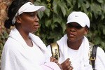 WIMBLEDON, ENGLAND - JUNE 18:  Venus Williams (L) and Serena Williams conclude their training session on the Aorangi Practice court at the All England Lawn Tennis and Croquet Club ahead of the Wimbledon Lawn Tennis Championships on June 18, 2011 in London, England. The Championships, which are celebrating their 125th anniversary this year, begin on June 20.   (Photo by Oli Scarff/Getty Images)