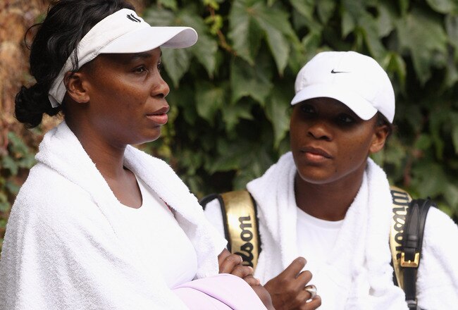 WIMBLEDON, ENGLAND - JUNE 18:  Venus Williams (L) and Serena Williams conclude their training session on the Aorangi Practice court at the All England Lawn Tennis and Croquet Club ahead of the Wimbledon Lawn Tennis Championships on June 18, 2011 in London, England. The Championships, which are celebrating their 125th anniversary this year, begin on June 20.   (Photo by Oli Scarff/Getty Images)