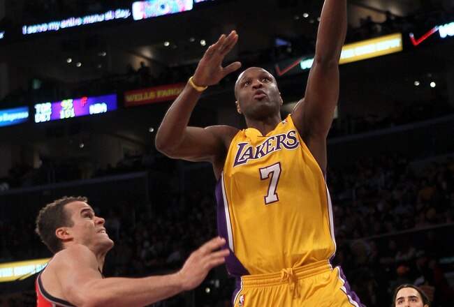 LOS ANGELES, CA - JANUARY 14: Lamar Odom #7 of the Los Angeles Lakers shoots over Kris Humphries #43 of the New Jersey Nets at Staples Center on January 14, 2011 in Los Angeles, California. The Lakers won 100-88.  NOTE TO USER: User expressly acknowledges and agrees that, by downloading and or using this photograph, User is consenting to the terms and conditions of the Getty Images License Agreement. (Photo by Stephen Dunn/Getty Images)