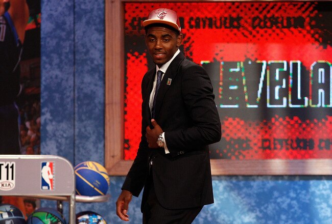 NEWARK, NJ - JUNE 23:  Kyrie Irving (R) from Duke smiles as he walks off stage after he was selected number one overall by the Cleveland Cavaliers in the first round during the 2011 NBA Draft at the Prudential Center on June 23, 2011 in Newark, New Jersey.  NOTE TO USER: User expressly acknowledges and agrees that, by downloading and/or using this Photograph, user is consenting to the terms and conditions of the Getty Images License Agreement.  (Photo by Mike Stobe/Getty Images)