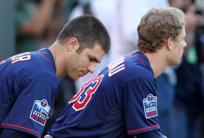 OAKLAND, CA - JUNE 04:  Justin Morneau #33 and Joe Mauer #7 of the Minnesota Twins look on against the Oakland Athletics during an MLB game at the Oakland-Alameda County Coliseum on June 4, 2010 in Oakland, California.  (Photo by Jed Jacobsohn/Getty Images)