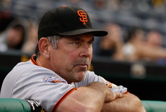 PITTSBURGH - APRIL 26:  Manager Bruce Bochy #15 of the San Francisco Giants watches the grounds crew prepare the field during a rain delay before the game against the Pittsburgh Pirates on April 26, 2011 at PNC Park in Pittsburgh, Pennsylvania.  (Photo by Jared Wickerham/Getty Images)