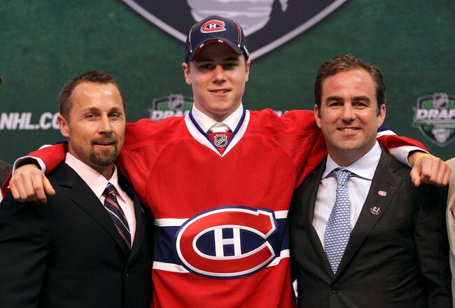 ST PAUL, MN - JUNE 24:  Seventh overall pick Nathan Beaulieu by the Montreal Canadiens stands onstage for a photo with Director of Procurement and Player Development Trevor Timmins  and a member of the Montreal Canadiens organization during day one of the 2011 NHL Entry Draft at Xcel Energy Center on June 24, 2011 in St Paul, Minnesota.  (Photo by Bruce Bennett/Getty Images)