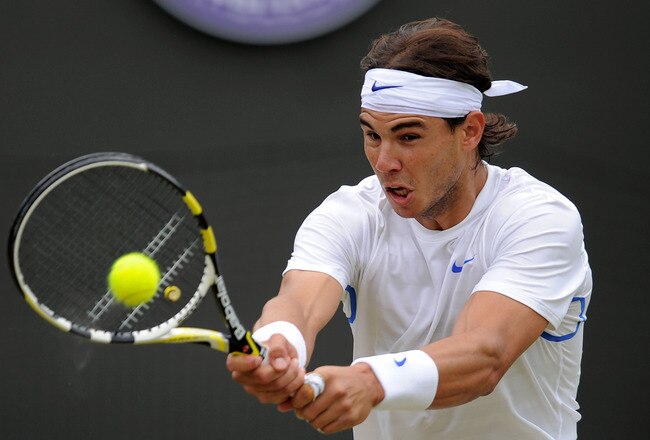 LONDON, ENGLAND - JUNE 25:   Rafael Nadal of Spain returns a shot during his third round match against Gilles Muller of Luxembourg on Day Six of the Wimbledon Lawn Tennis Championships at the All England Lawn Tennis and Croquet Club on June 25, 2011 in London, England.  (Photo by Michael Regan/Getty Images)