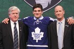 ST PAUL, MN - JUNE 24:  22nd overall pick Tyler Biggs by the Toronto Maple Leafs stands onstage for a photo with President & General Manager Brian Burke (L) and a member of the Toronto Maple Leafs organization during day one of the 2011 NHL Entry Draft at Xcel Energy Center on June 24, 2011 in St Paul, Minnesota.  (Photo by Bruce Bennett/Getty Images)