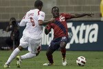 HOUSTON - JUNE 22:  Freddy Adu #20 of the U.S.A. attempts to control the ball as he his defended by Gabriel Gomez #6 of Panama in the second half at Reliant Stadium on June 22, 2011 in Houston, Texas.  (Photo by Bob Levey/Getty Images)