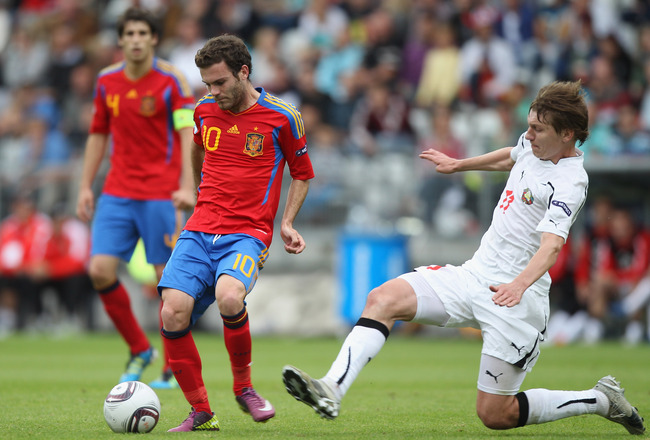 VIBORG, DENMARK - JUNE 22:  Juan Mata (L) of Spain feeds a pass as Pavel Nekhaychik (R) challenges during the UEFA European Under-21 Championship semi-final match between Belarus and Spain at the Viborg Stadium on June 22, 2011 in Viborg, Denmark.  (Photo by Michael Steele/Getty Images)