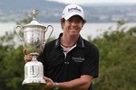 BELFAST, NORTHERN IRELAND - JUNE 22:  US Open winning golfer Rory McIlroy poses with his trophy on a green at Holywood Golf Club on June 22, 2011 in Belfast, Northern Ireland. The 22 year old golfer has returned home to his native Northern Ireland and is giving press interviews and meeting with local supporters.  (Photo by Peter Macdiarmid/Getty Images)