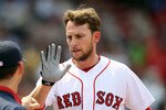BOSTON, MA - JUNE 01:  Jed Lowrie #12 of the Boston Red Sox is congratulated after he scored in the second inning against the Chicago White Sox on June 1, 2011 at Fenway Park in Boston, Massachusetts.  (Photo by Elsa/Getty Images)