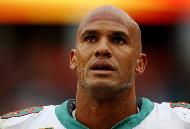 MIAMI - JANUARY 03:  Linebacker Jason Taylor #99 of the Miami Dolphins looks up as the last few moments of the game tick away against the Pittsburgh Steelers calls out a play at the line of scrimmage at Land Shark Stadium on January 3, 2010 in Miami, Florida. The Steelers defeated the Dolphins 30-24.  (Photo by Doug Benc/Getty Images)
