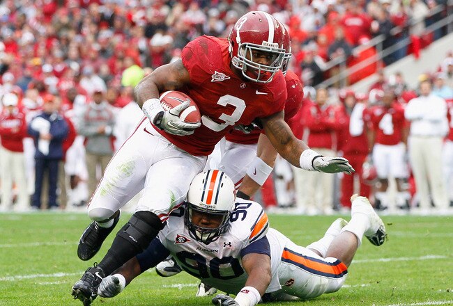 TUSCALOOSA, AL - NOVEMBER 26:  Trent Richardson #3 of the Alabama Crimson Tide is tackled by Nick Fairly #90 of the Auburn Tigers at Bryant-Denny Stadium on November 26, 2010 in Tuscaloosa, Alabama.  (Photo by Kevin C. Cox/Getty Images)